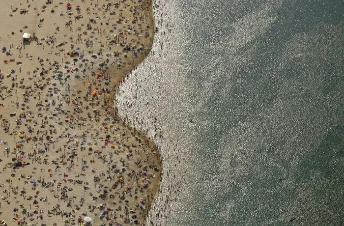 Framed Print : An aerial view shows people at a beach on the shores of the Silbersee lake on a hot Framed Print : An aerial view shows people at a beach on the shores of the Silbersee lake on a hot
