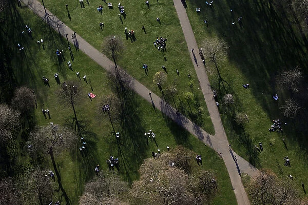 An aerial view shows people sitting in Greenwich Park in London
