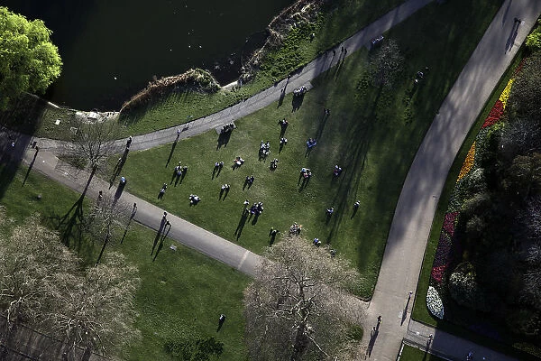 An aerial view shows people sitting in a Park in London