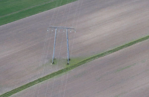 Aerial view shows pylon of high-tension electricity power lines in a field in Royan