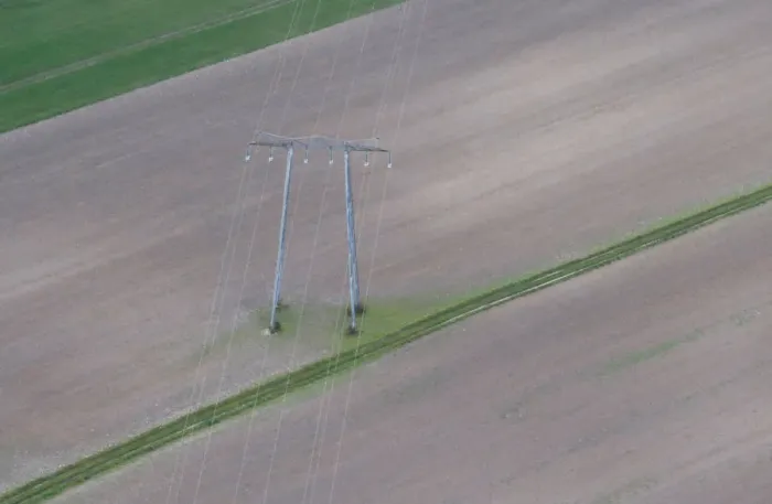 Framed Print : Aerial view shows pylon of high-tension electricity power lines in a field in Royan