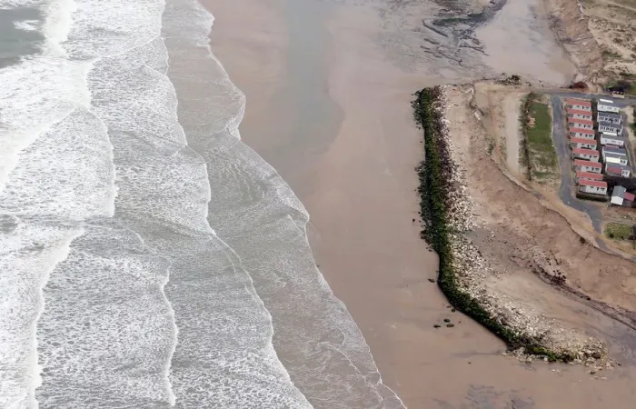 Framed Print : An aerial view shows a sea wall on the beach that protects camping sites Framed Print : An aerial view shows a sea wall on the beach that protects camping sites