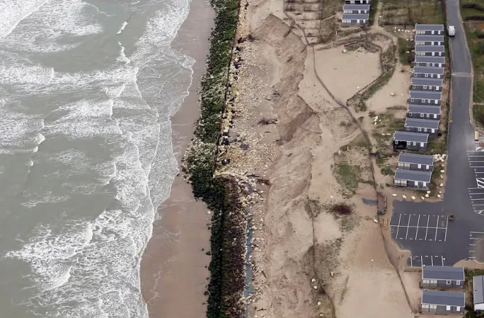 Framed Print : An aerial view shows sea walls on the beach that protect camping Framed Print : An aerial view shows sea walls on the beach that protect camping