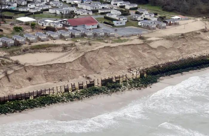 Framed Print : An aerial view shows sea walls on the beach that protect camping areas