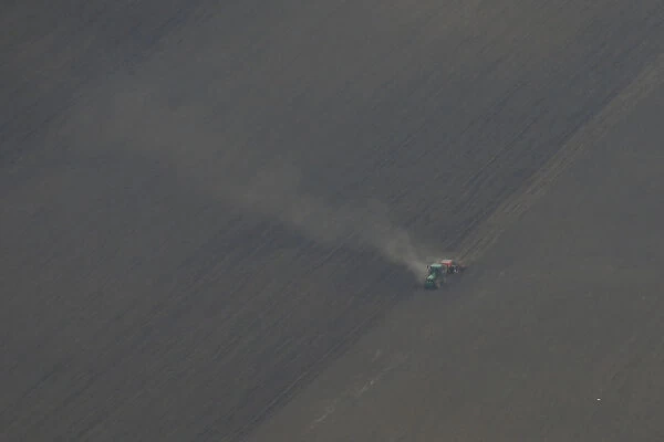 An aerial view shows a tractor plowing a field near Boryspil