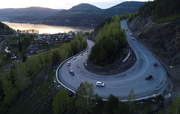 An aerial view shows vehicles driving along a highway outside Krasnoyarsk