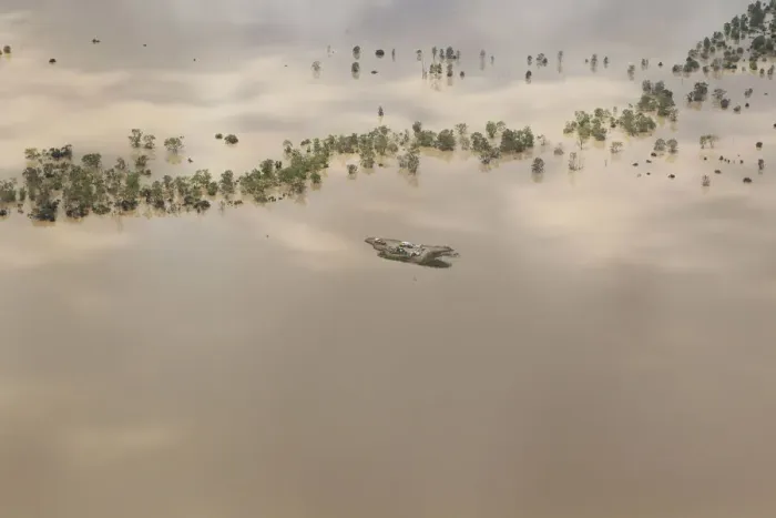 Framed Print : Agricultural machinery is seen on an isolated island surrounded by flood waters near Framed Print : Agricultural machinery is seen on an isolated island surrounded by flood waters near