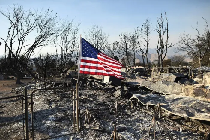 Framed Print : An American flag flies above wreckage at a residence leveled by the Erskine Fire in South