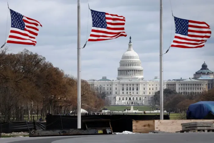 Framed Print : American flags fly with U. S. Capitol on background
