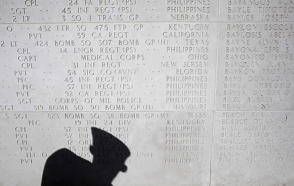 An American views the memorial hall where the names of fallen U