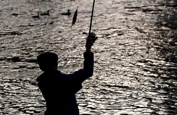 An angler casts his line on the opening day of the salmon fishing season on the River Tay