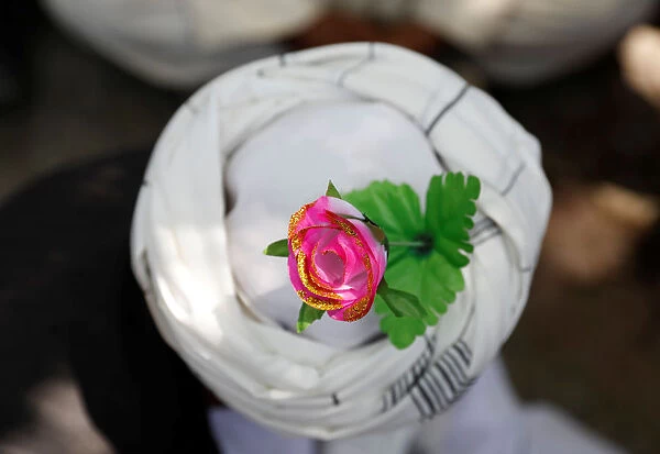 An artificial flower is seen on a turban of a peace marcher as he arrives in Kabul