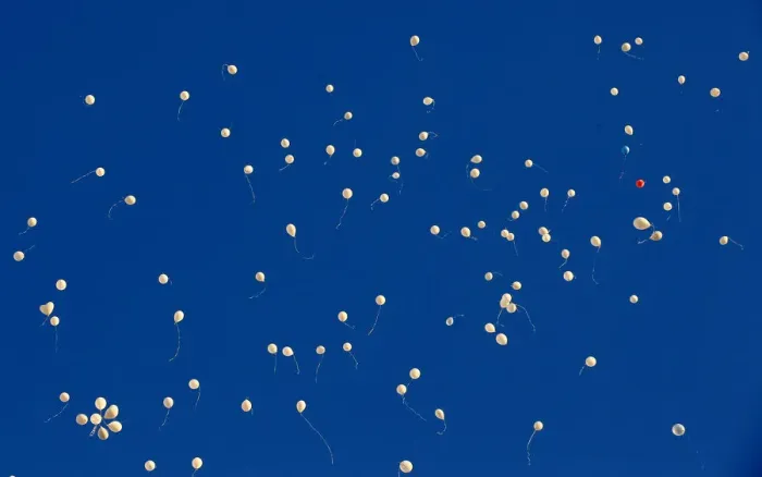 Framed Print : Balloons fly after being released by people who gather to commemorate the victims of a Framed Print : Balloons fly after being released by people who gather to commemorate the victims of a