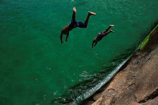 Bathers dive into the sea at the Leme beach in Rio de Janeiro