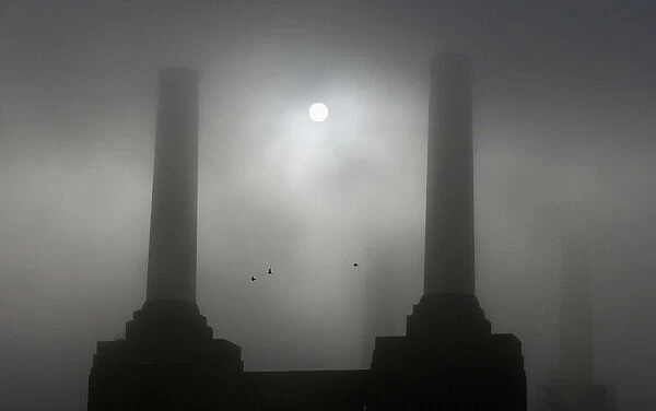 Battersea Power Station is seen shrouded in fog along the river Thames in London
