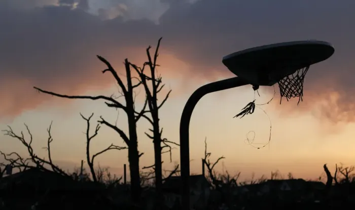 Framed Print : A bent basketball goal stands in a park next to a bare tree after a devastating tornado Framed Print : A bent basketball goal stands in a park next to a bare tree after a devastating tornado