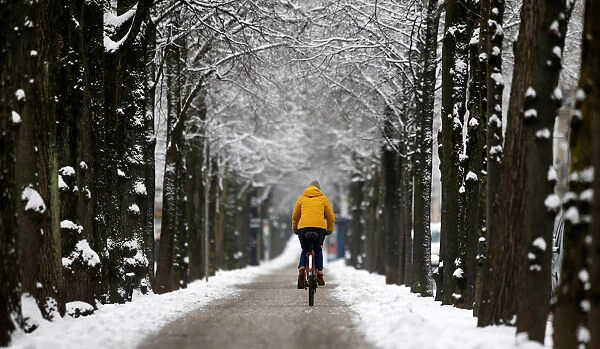 A bicyclist is seen in the snow covered Munich