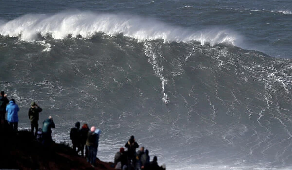 Big-wave surfer Sebastian Steudtner of Germany drops in a large wave at Praia do Norte in