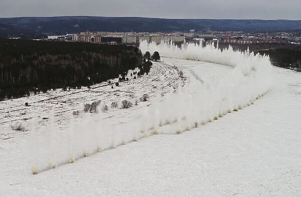A blast rips through the ice covering the Kan river to reduce the risk of floods