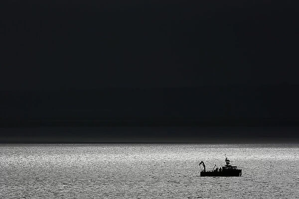 A boat sails on the Thames Estuary near Stanford-le-Hope to the east of London