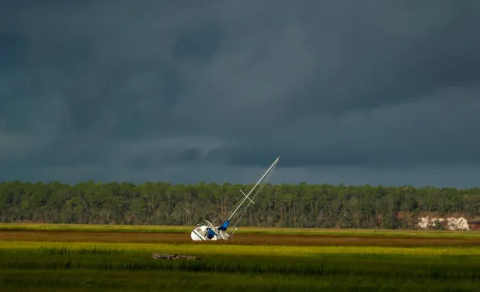 Framed Print : A boat is seen after being blown from the dock into the marsh after Hurricane Irma passed