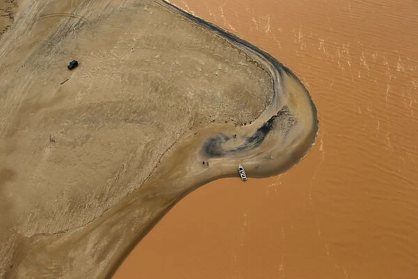 A boat is seen on the mouth of Rio Doce (Doce River), which was flooded with mud after