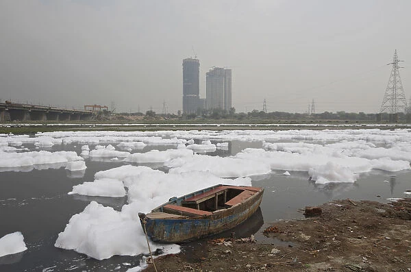 A boat is seen parked in the polluted water of the river Yamuna ahead of World Water Day