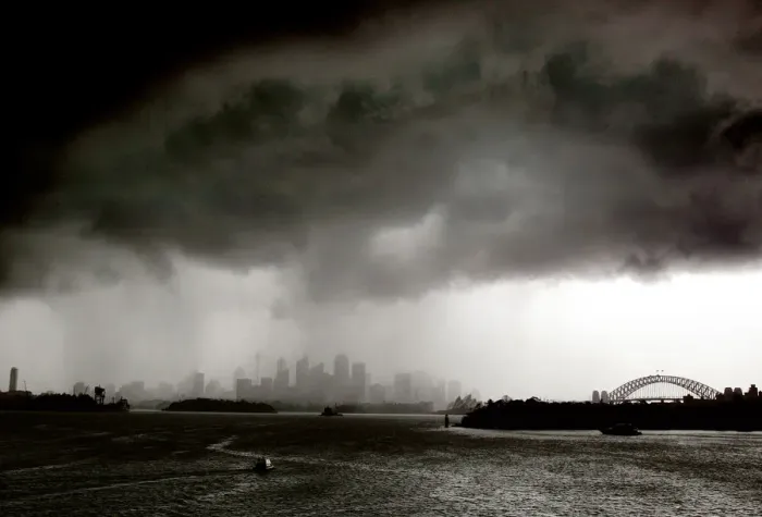 Framed Print : Boats sail on Sydney harbour as a severe storm hits the city