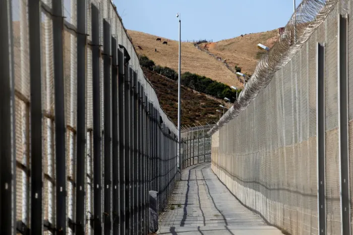 Framed Print : The border fence separating Spains northern enclave Ceuta and Morocco is seen from Ceuta