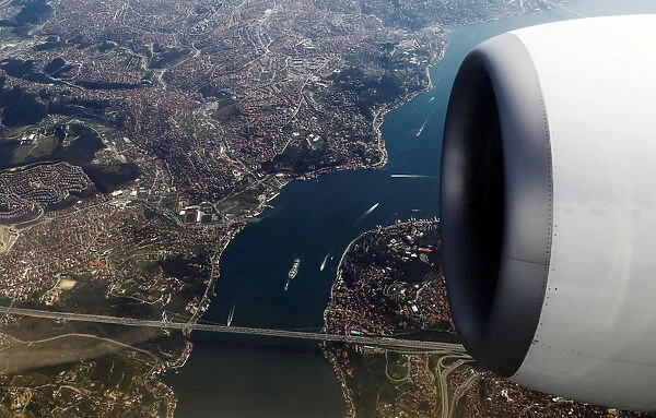 Bosphorus strait and the Fatih Sultan Mehmet bridge are pictured through the window of a