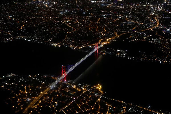 Bosphorus strait and the Fatih Sultan Mehmet Bridge are pictured through the window of a