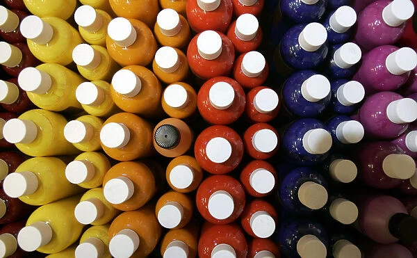 Bottles of coloured inks used for tattooing are displayed for sale at the International