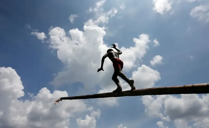 Framed Print : A boy climbs up a greasy pole in a climbing competition at a part of Sinhala Framed Print : A boy climbs up a greasy pole in a climbing competition at a part of Sinhala