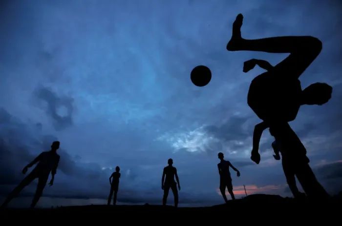 Framed Print : A boy kicks a ball as he plays soccer with his friends at Galle Dutch Fort in Galle Framed Print : A boy kicks a ball as he plays soccer with his friends at Galle Dutch Fort in Galle