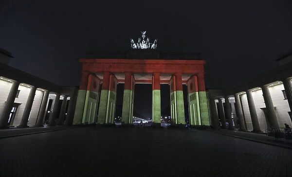 Brandenburg Gate is illuminated to commemorate the 12 killed victims of a truck that