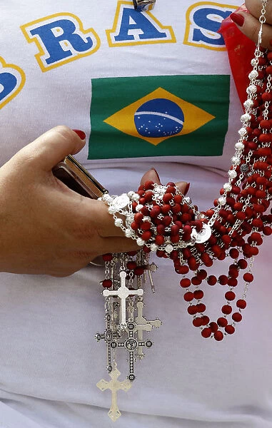 A Brazilian faithful holds rosaries as Pope Benedict XVI leads the Sunday Angelus prayer