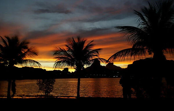 A Brazilian walks at sunset on Rodrigo de Freitas Lake in Rio