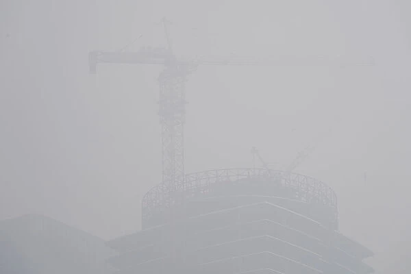 A building under construction is seen amid heavy smog in Beijings central business area
