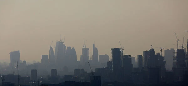 Buildings and construction cranes are seen through a heat haze in London
