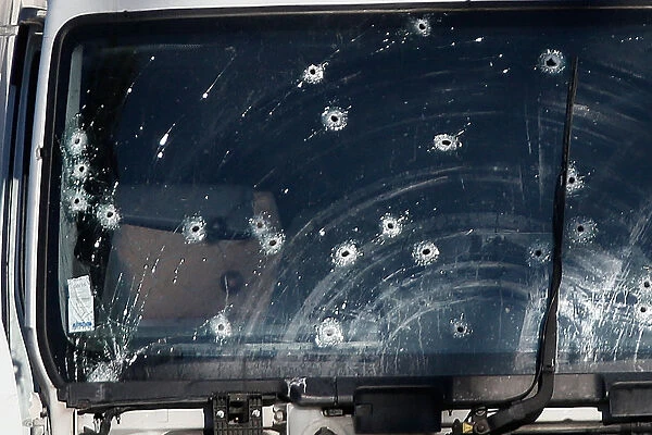 Bullet impacts are seen on the heavy truck the day after it ran into a crowd at high