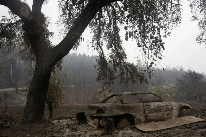 Framed Print : A burned car is seen in a local road following a forest fire outside Pedrogao Grande Framed Print : A burned car is seen in a local road following a forest fire outside Pedrogao Grande