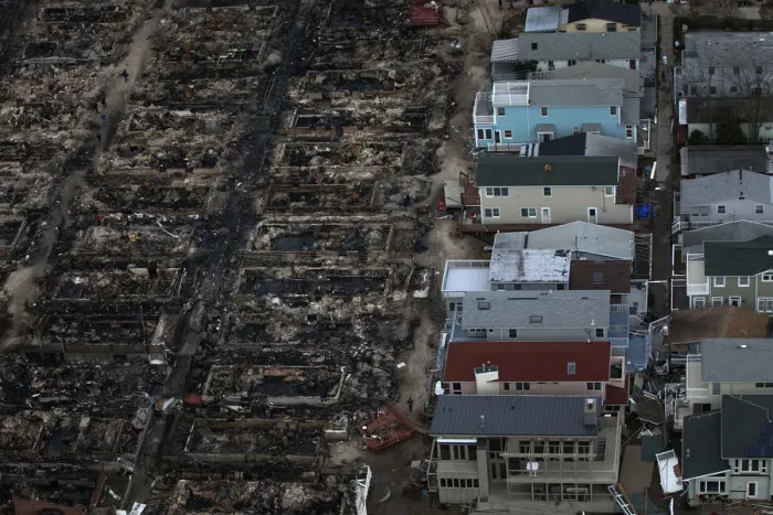 Framed Print : Burned houses are seen next to those which survived in Breezy Point after they were Framed Print : Burned houses are seen next to those which survived in Breezy Point after they were
