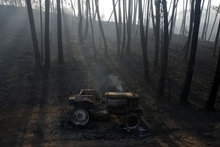 Framed Print : A burned out tractor is seen amidst burned trees after a forest fire in Castanheira de Framed Print : A burned out tractor is seen amidst burned trees after a forest fire in Castanheira de