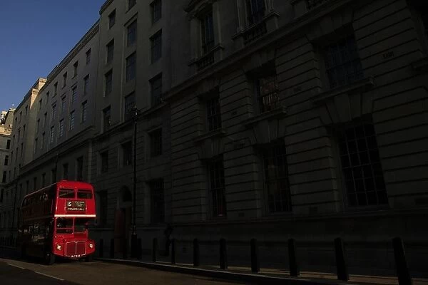 A bus is parked in a street in central London