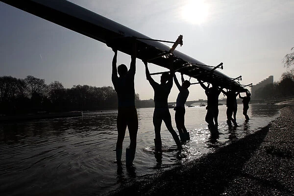 The Cambridge University rowing crew prepare for a training session on the River Thames