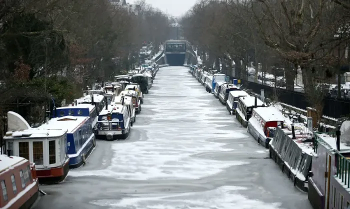 Framed Print : Canal boats are frozen at their berths on the Regents Canal in Maida Vale in London