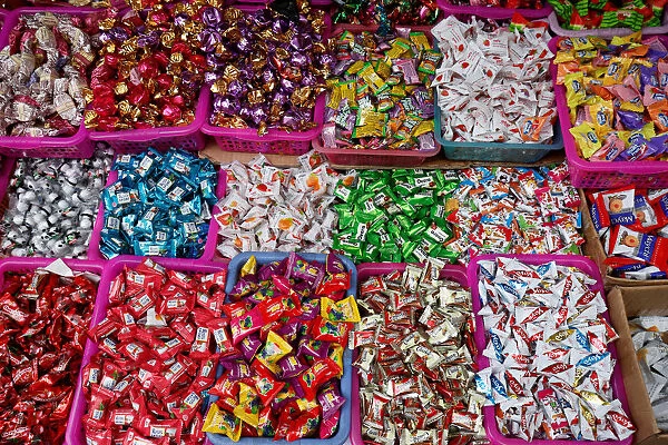 Candies are displayed for sale on a street in Hanoi