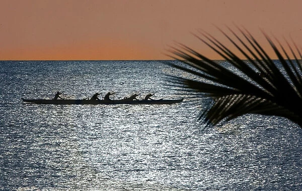 Canoe club members practice in the Pacific Ocean off Haleiwa Hawaii