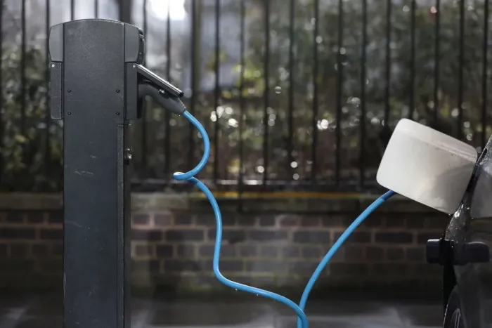 Framed Print : A car is plugged in at a charging point for electric vehicles in London Framed Print : A car is plugged in at a charging point for electric vehicles in London