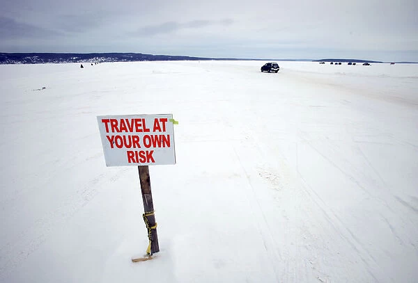 Car travels the ice road on Lake Superior between Bayfield, Wisconsin and Madeline Island